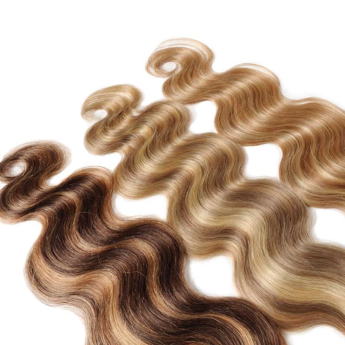 Wavy strands of blonde, brown, and black hair displayed on a white background.