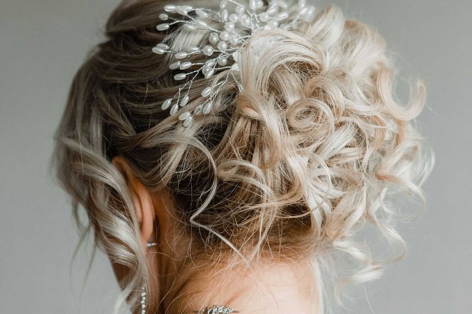 Bridal hairstyle with pearl accessories from behind.