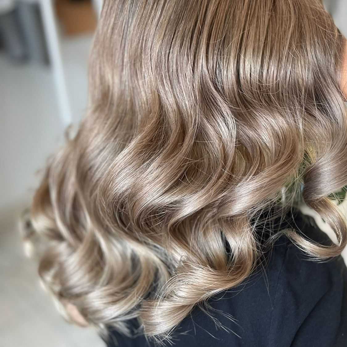 Close-up of wavy light brown hair with soft highlights.